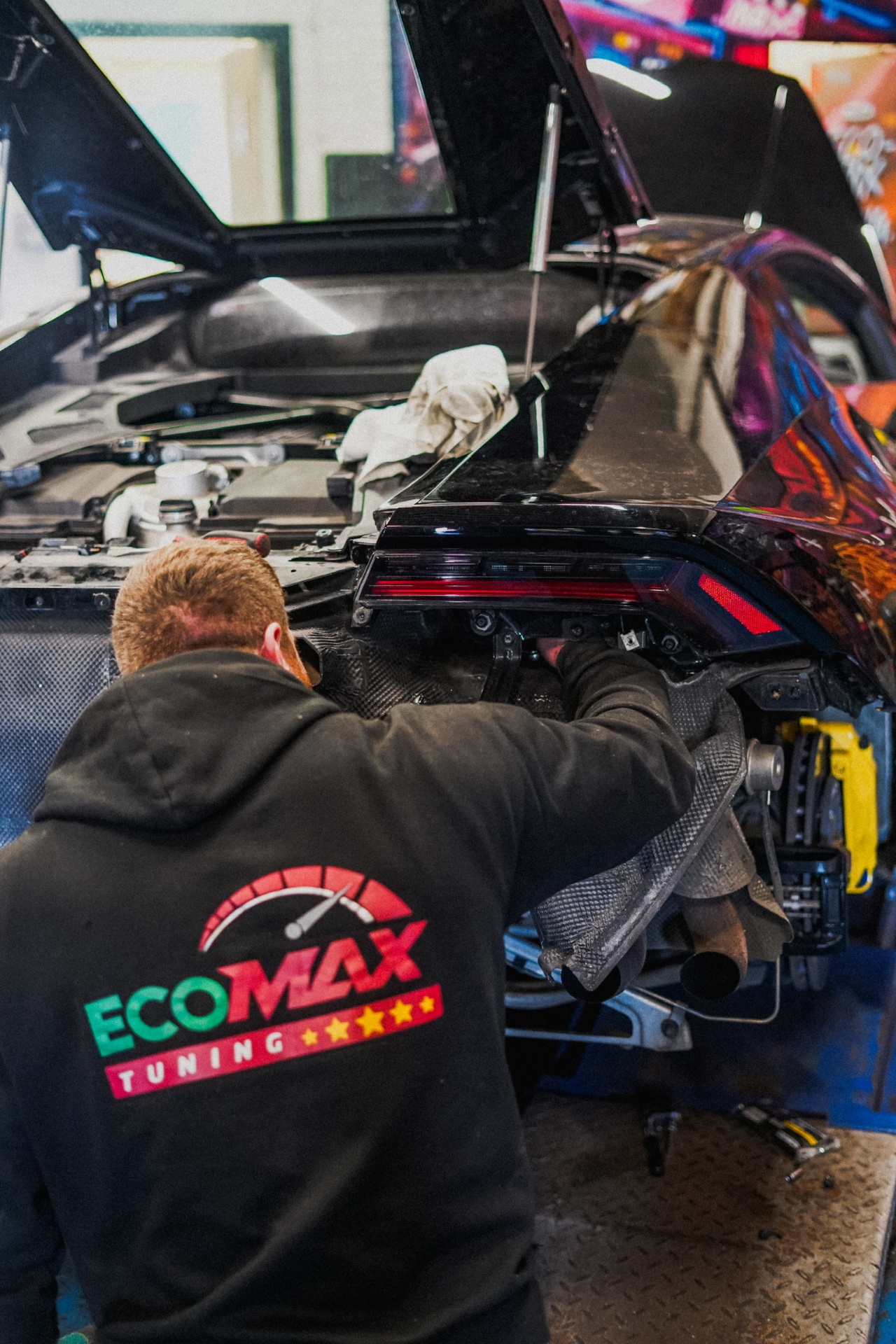 EcoMax technician working on vehicle engine